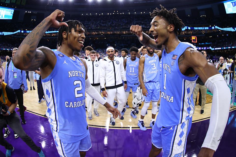 North Carolina's Caleb Love (left) and Leaky Black celebrate their team's win over Duke in the Final Four on Saturday. (Jamie Schwaberow/NCAA Photos via Getty Images)