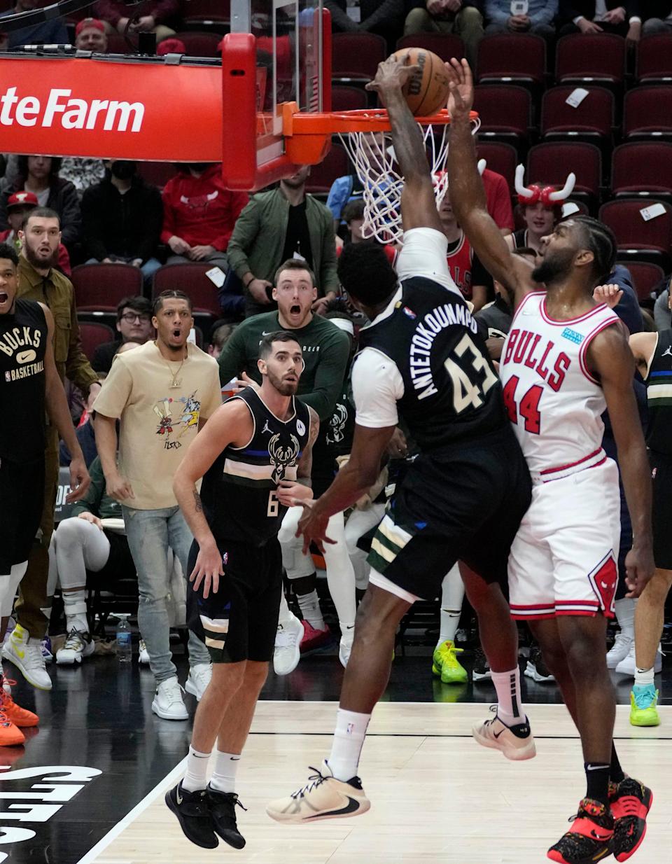 Milwaukee Bucks forward Thanasis Antetokounmpo (43) dunks over Chicago Bulls forward Patrick Williams (44) as his teammates react during the fourth quarter of their 111-81 playoff game win Friday at the United Center.