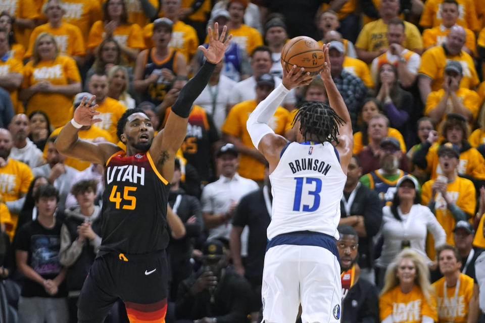 Dallas Mavericks guard Jalen Brunson shoots as Utah Jazz guard Donovan Mitchell defends during Game 3 of their NBA playoffs first-round playoff series on April 21, 2022, in Salt Lake City. (AP Photo/Rick Bowmer)