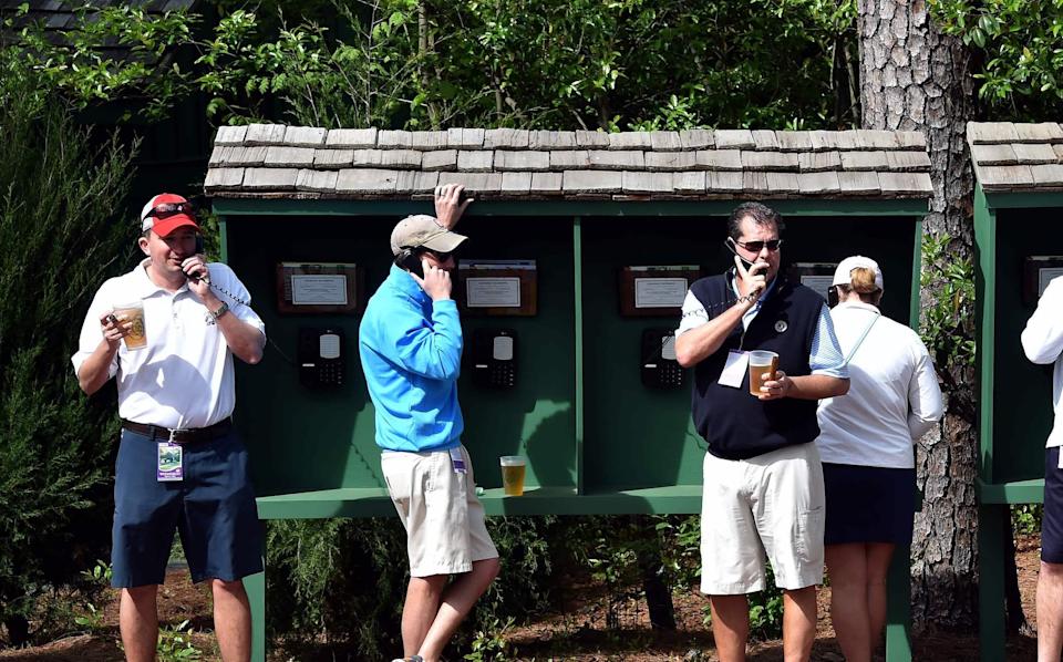 Masters patrons using pay phones.