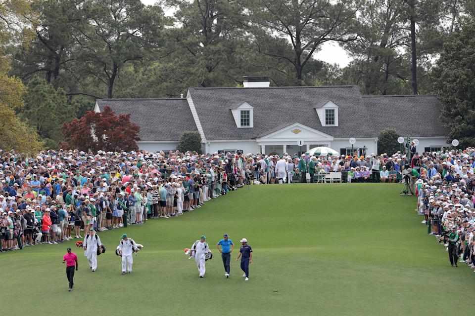 AUGUSTA, GEORGIA - APRIL 07: The group of Tiger Woods, Joaquin Niemann of Chile, and Louis Oosthuizen of South Africa walks off the first tee during the first round of the Masters at Augusta National Golf Club on April 07, 2022 in Augusta, Georgia. (Photo by Jamie Squire/Getty Images)