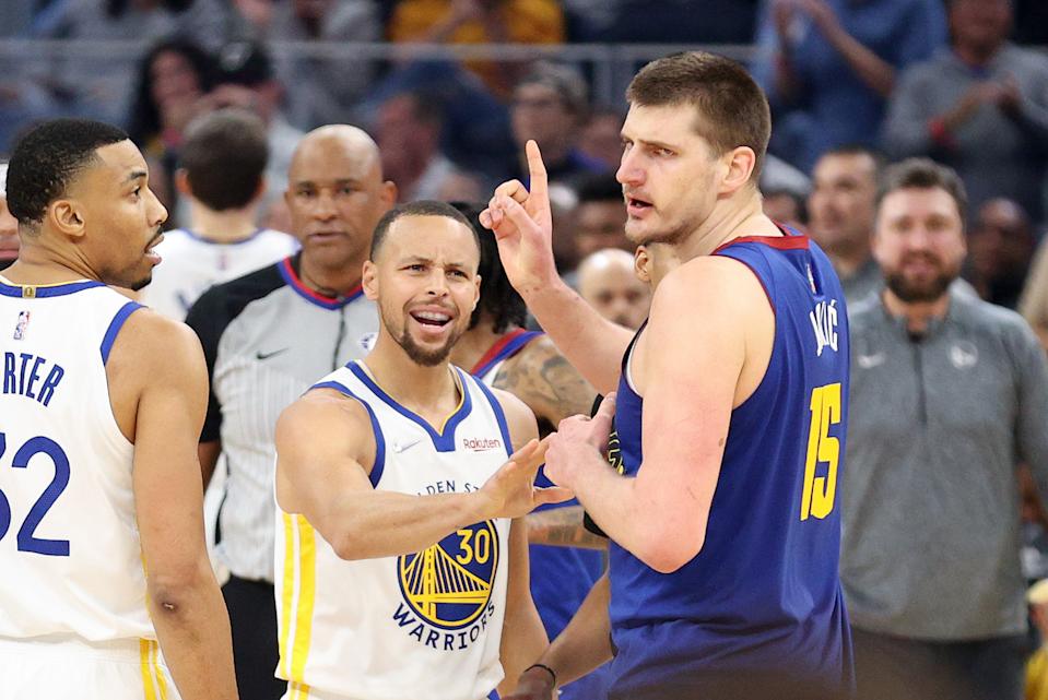 Stephen Curry of the Golden State Warriors has words with Nikola Jokic of the Denver Nuggets