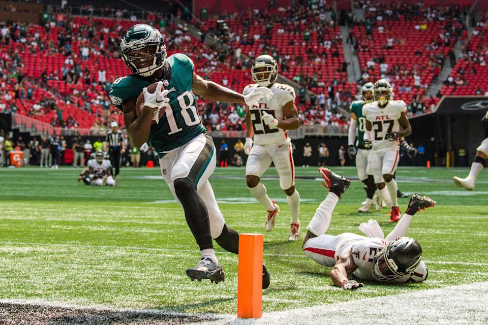 Philadelphia Eagles wide receiver Jalen Reagor (18) scores a touchdown past Atlanta Falcons strong safety Duron Harmon (21) during the second half of an NFL football game, Sunday, Sep. 12, 2021, in Atlanta. The Philadelphia Eagles won 32-6. (AP Photo/Danny Karnik)