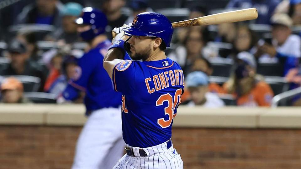 Sep 30, 2021; New York City, New York, USA; New York Mets right fielder Michael Conforto (30) hits an RBI single during the third inning against the Miami Marlins at Citi Field.