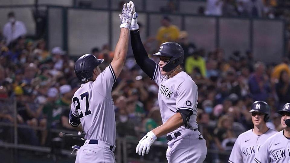 Giancarlo Stanton and Aaron Judge celebrate a HR on road close up Stanton back turned