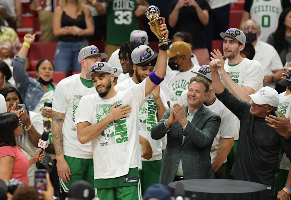 Boston Celtics forward hoists the first-ever Larry Bird Eastern Conference Finals MVP trophy after defeating the Miami Heat in Game 7. (Jim Rassol/USA Today Sports)