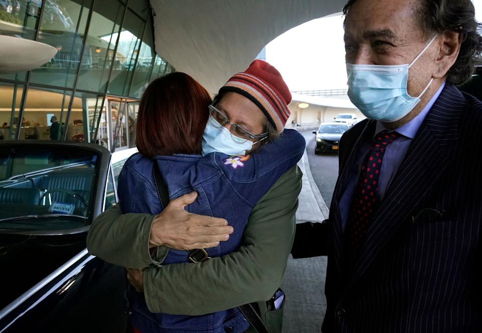 TOPSHOT - US journalist Danny Fenster (C) is reunited with his mother Rose Fenster at JFK airport on November 16, 2021. - Fenster is escoted by former US Ambassador to the UN Bill Richardson. Fenster returns to the US after being released from prison in Myanmar after he was sentenced to 11 years in jail by a military court on November 13, 2021. (Photo by TIMOTHY A. CLARY / AFP) (Photo by TIMOTHY A. CLARY/AFP via Getty Images)