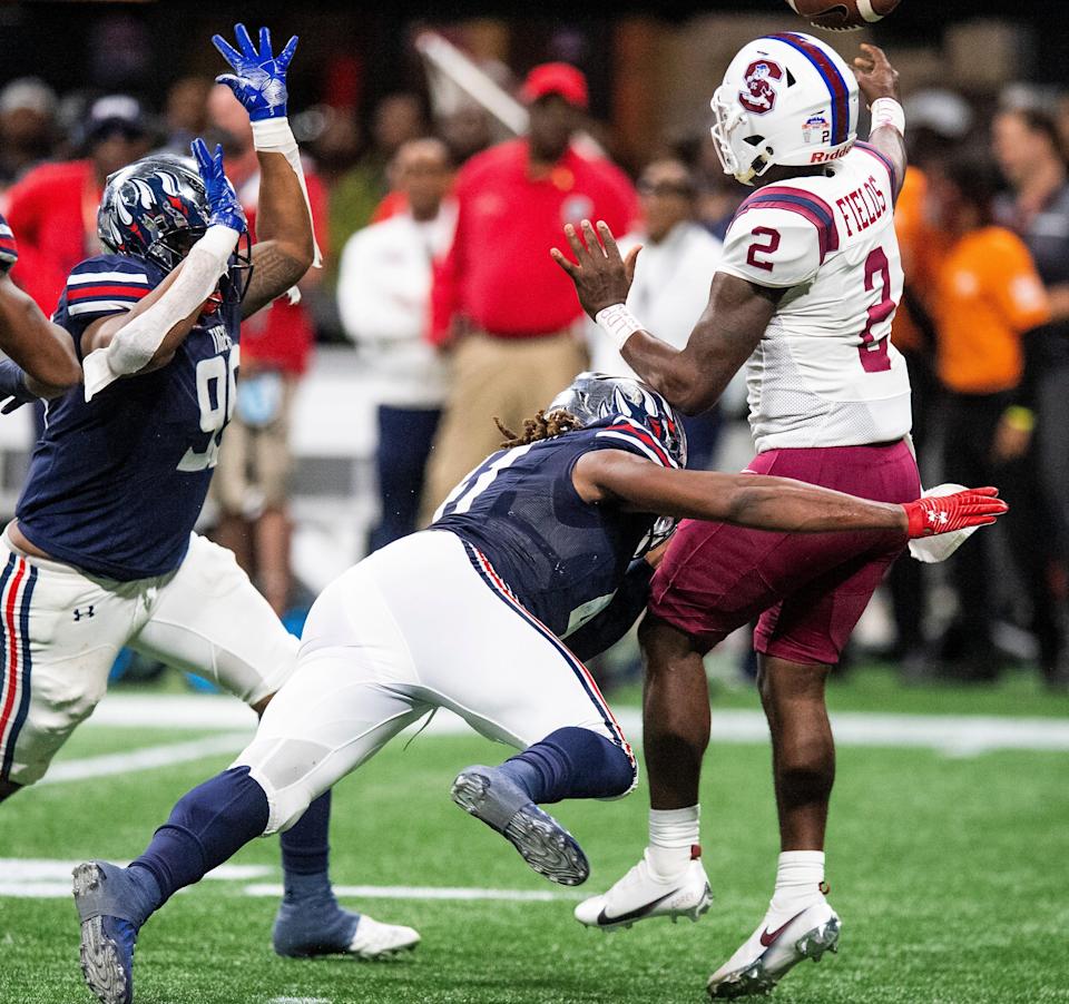 Jackson State defensive lineman Antwan Owens (99) and linebacker James Houston (41) pressure South Carolina State wide receiver Shaquan Davis (1) as he passes during the Celebration Bowl in Atlanta, Ga., on Saturday December 18, 2021.