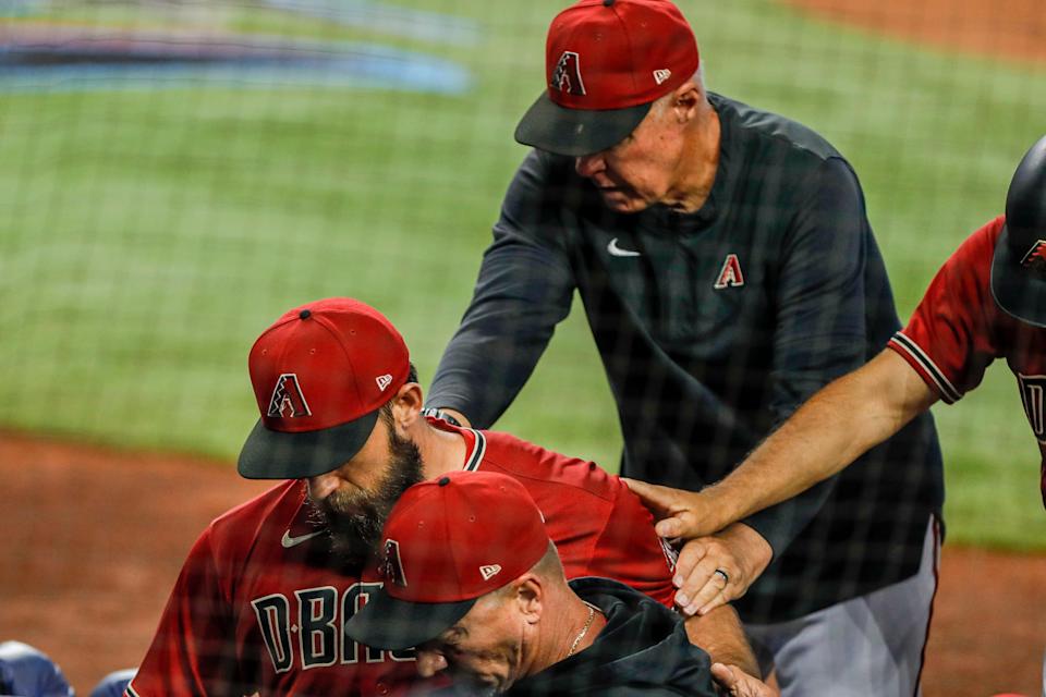 May 4, 2022; Miami, Florida, USA; Arizona Diamondbacks starting pitcher Madison Bumgarner (40) gets taken out of the game after getting ejected from the game during the first inning against the Miami Marlins at loanDepot Park.