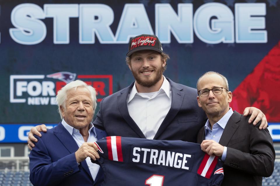 New England Patriots owner Robert Kraft, left, and Patriots president Jonathan Kraft, right, pose with Patriots NFL football first round draft pick, offensive linesman Cole Strange. at Gillette Stadium, Friday, April 29, 2022, in Foxborough, Mass. (AP Photo/Michael Dwyer)