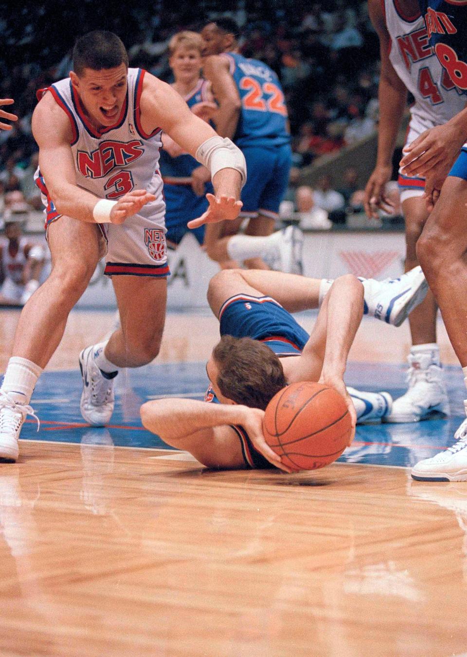 New Jersey Nets' Drazen Petrovic, left, closes in on Cleveland Cavaliers' Danny Ferry as Petrovic dives at Meadowlands Arena in East Rutherford, N.J., April 28, 1992.