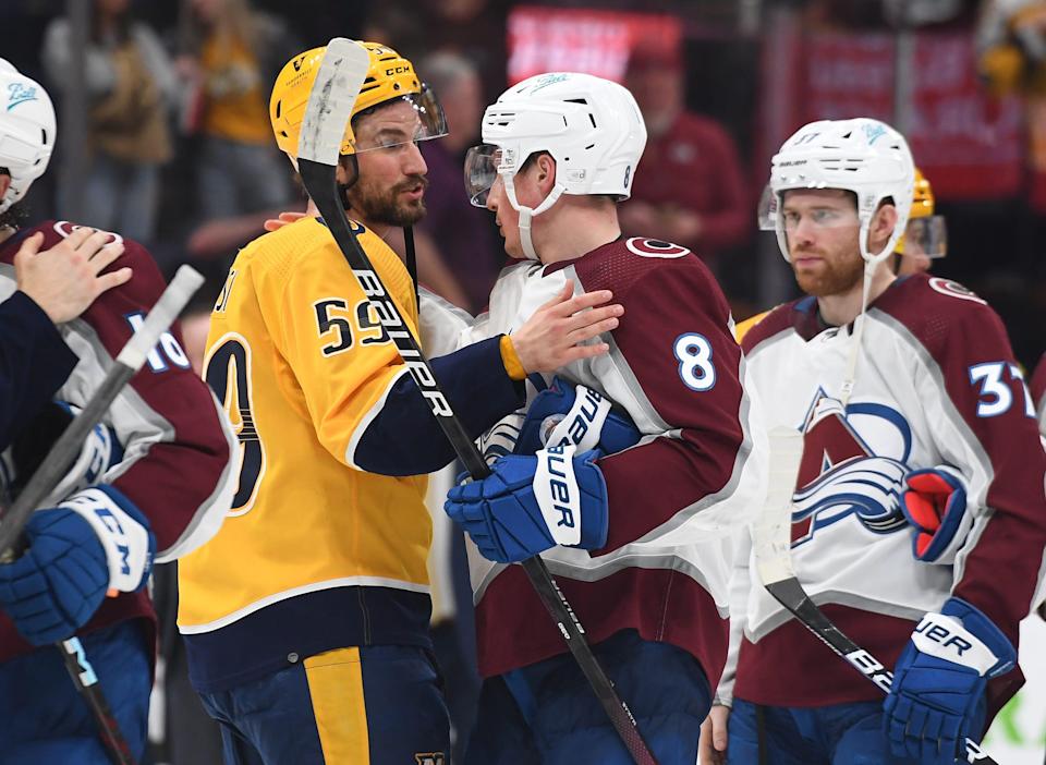 Nashville Predators defenseman Roman Josi (59) and Colorado Avalanche defenseman Cale Makar shake hands after their playoff series.