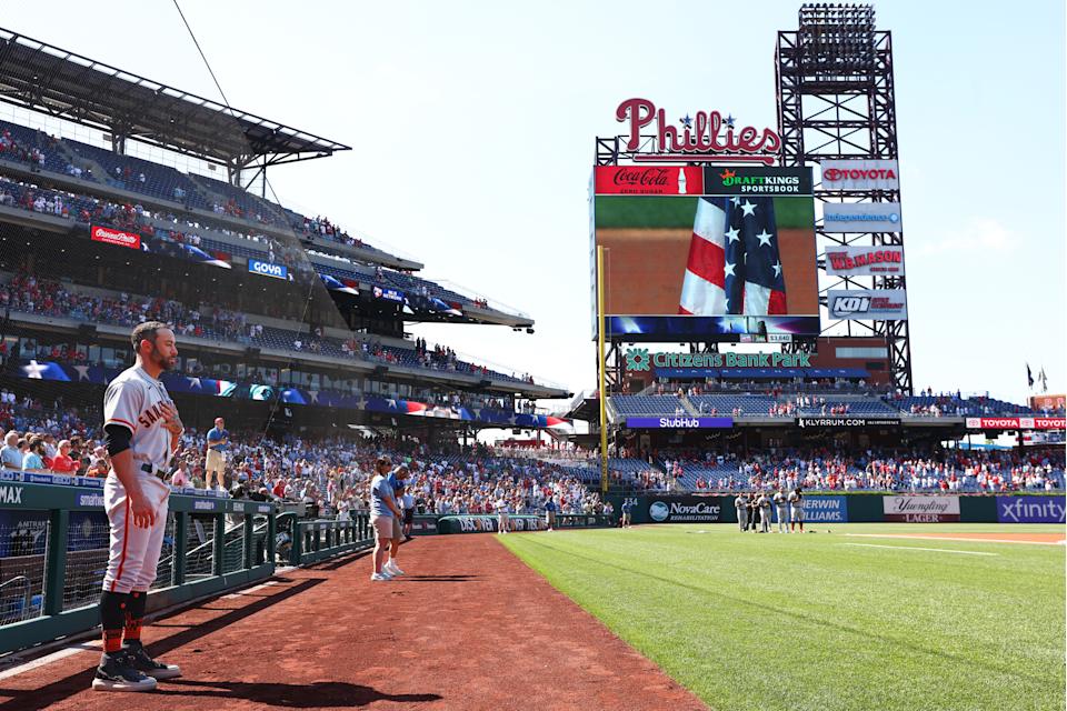 Gabe Kapler #19 of the San Francisco Giants stands for the National Anthem prior to a game against the Philadelphia Phillies at Citizens Bank Park on May 30, 2022 in Philadelphia, Pennsylvania. Kapler has stated that he would not be on the field for the anthem as a protest but made an exception for Memorial day. (Photo by Rich Schultz/Getty Images)