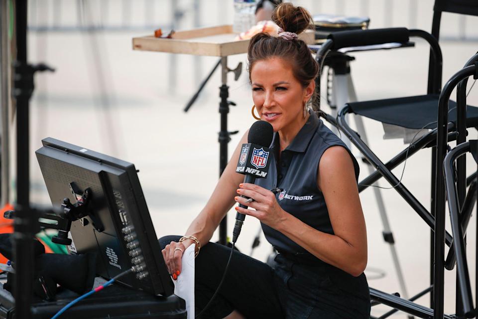 NFL Network reporter Kay Adams prepares to go on the air outside of Lambeau Field during NFL training camp on July 31, 2021.