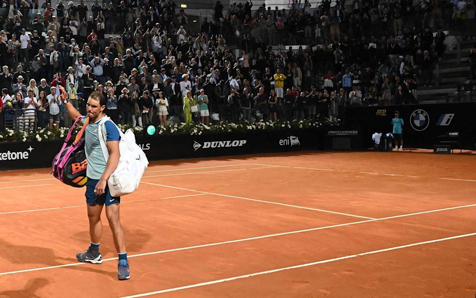 A distraught Rafael Nadal waves goodbye to the crowd - AFP