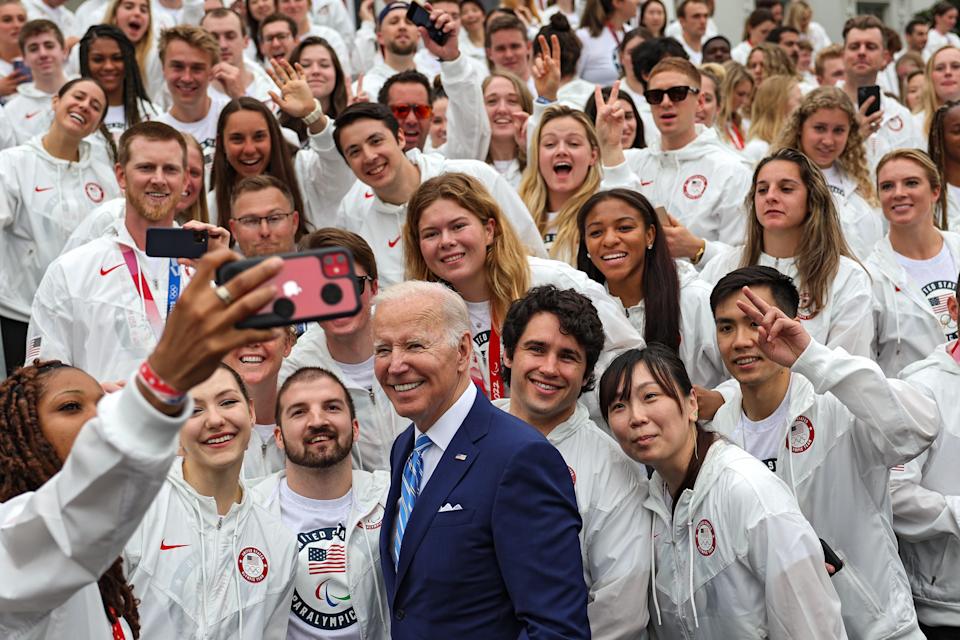 Katie Ledecky, somewhere back there, and other members of Teams USA Olympians and Paralympians from the Tokyo and Beijing Games were recognized by President Biden at the White House Wednesday.