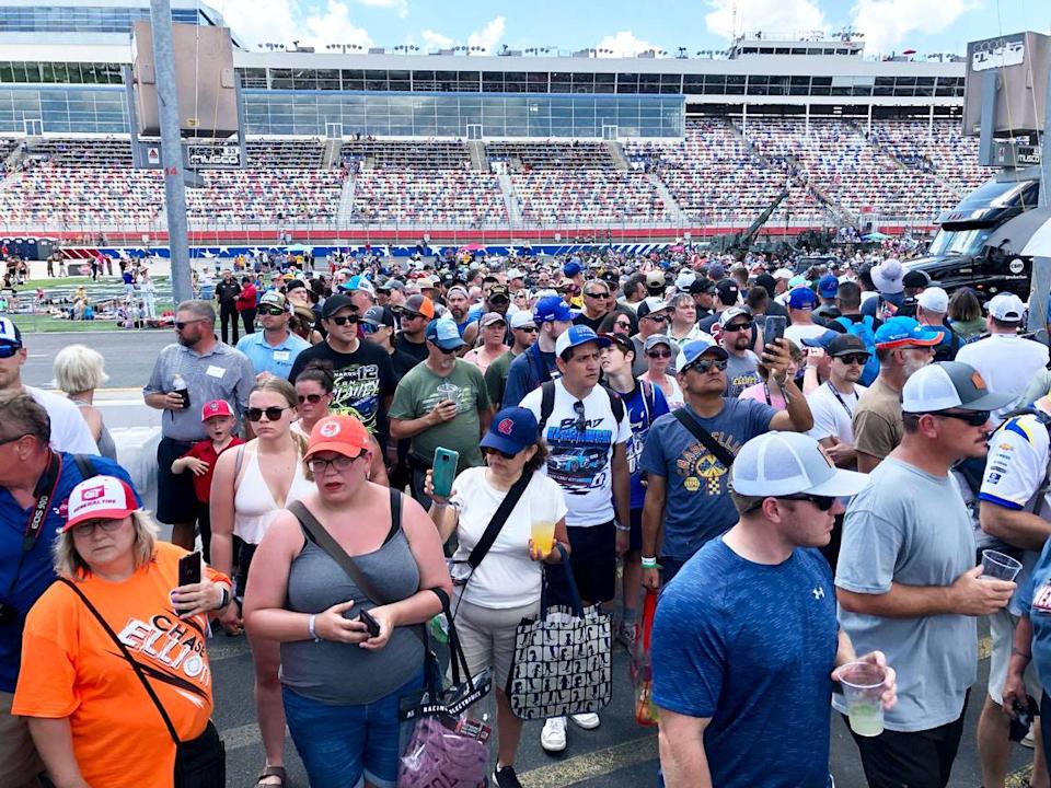 NASCAR fans mingle around pit road and behind the pit boxes at the Coca-Cola 600 on Sunday, May 29, 2022 at Charlotte Motor Speedway.