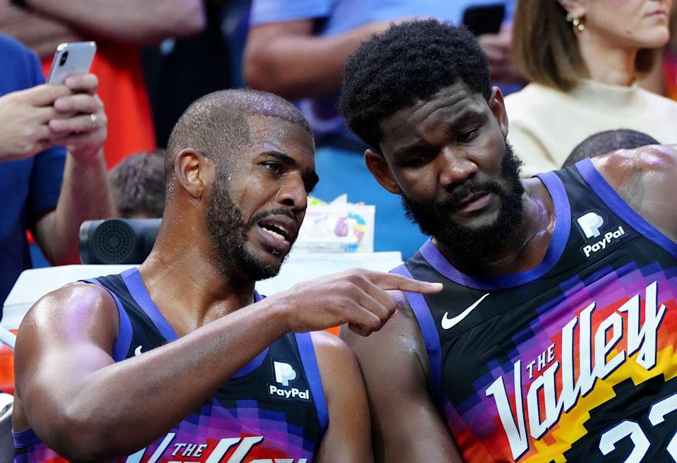 May 10, 2022; Phoenix, Arizona; USA; Suns guard Chris Paul talks with center Deandre Ayton on the bench during game 5 of the second round of the Western Conference Playoffs.