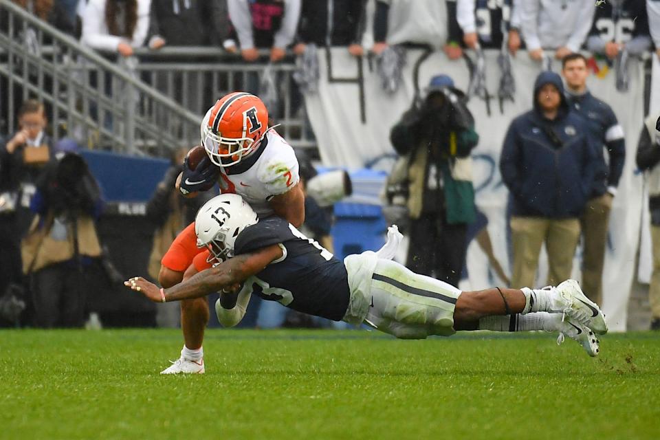 Oct 23, 2021; University Park, Pennsylvania, USA; Penn State Nittany Lions linebacker Ellis Brooks (13) dives at Illinois Fighting Illini running back Chase Brown (2) during the first half at Beaver Stadium. Mandatory Credit: Rich Barnes-USA TODAY Sports