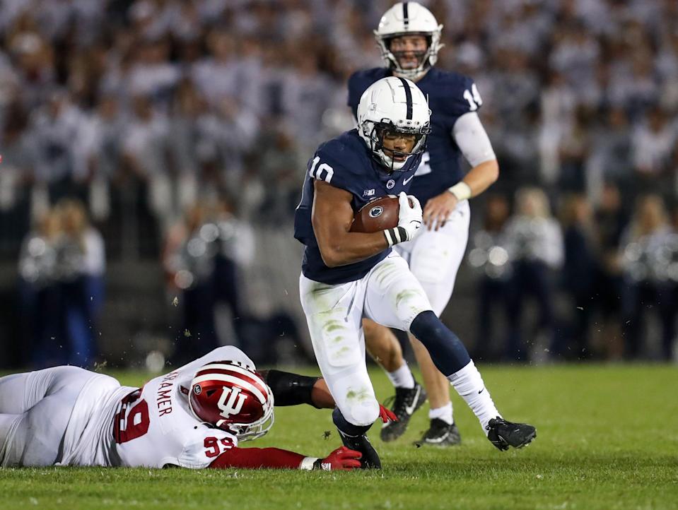 Oct 2, 2021; University Park, Pennsylvania, USA; Indiana Hoosiers defensive linesman Weston Kramer (99) attempts to tackle Penn State Nittany Lions running back John Lovett (10) as he runs the ball during the third quarter at Beaver Stadium. Mandatory Credit: Matthew OHaren-USA TODAY Sports