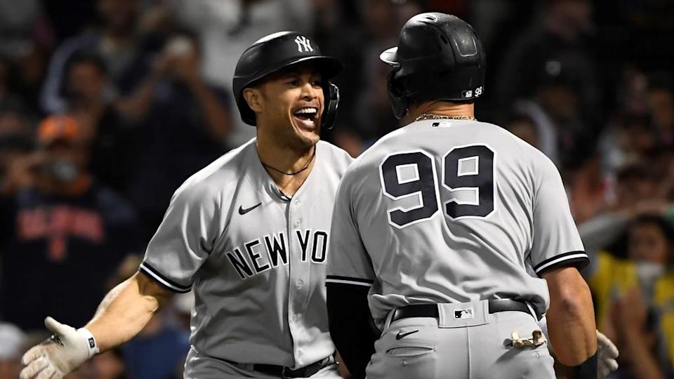 Giancarlo Stanton and Aaron Judge (back turned) celebrate HR in on deck circle on road