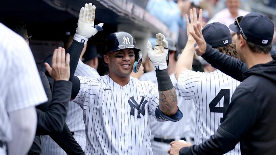 Gleyber Torres getting high fives in dugout after HR in home day game