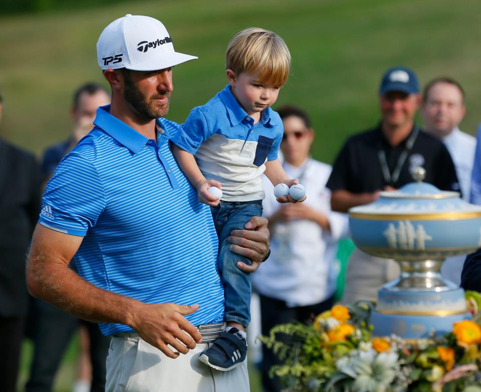 Dustin Johnson and son Tatum admire The Walter Hagen Trophy, presented to the winner of the World Golf Classic - Dell Match Play on March 26, 2017.