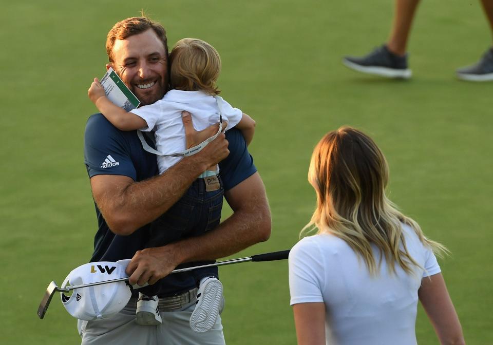 Dustin Johnson celebrates with wife Paulina Gretzky and son Tatum after winning the U.S. Open at Oakmont Country Club on June 19, 2016, in Oakmont, Pennsylvania.