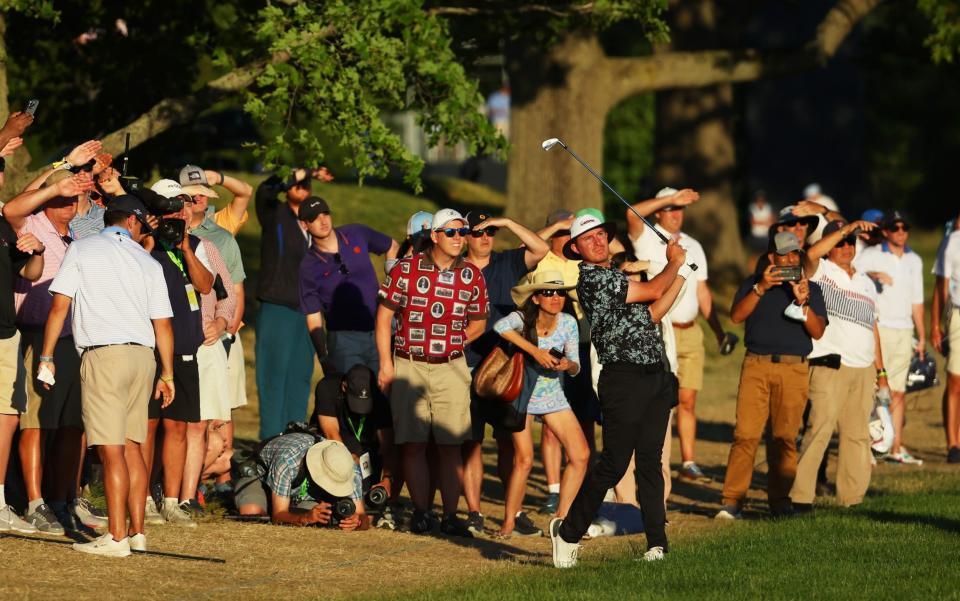 Joel Dahmen of the United States plays a shot on the 18th hole - Getty Images