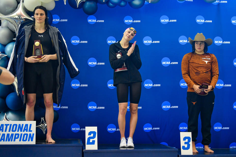 ATLANTA, GA - MARCH 17: University of Pennsylvania swimmer Lia Thomas accepts the winning trophy for the 500 Freestyle finals as second place finisher Emma Weyant and third place finisher Erica Sullivan watch during the NCAA Swimming and Diving Championships on March 17th, 2022 at the McAuley Aquatic Center in Atlanta Georgia. (Photo by Rich von Biberstein/Icon Sportswire via Getty Images)