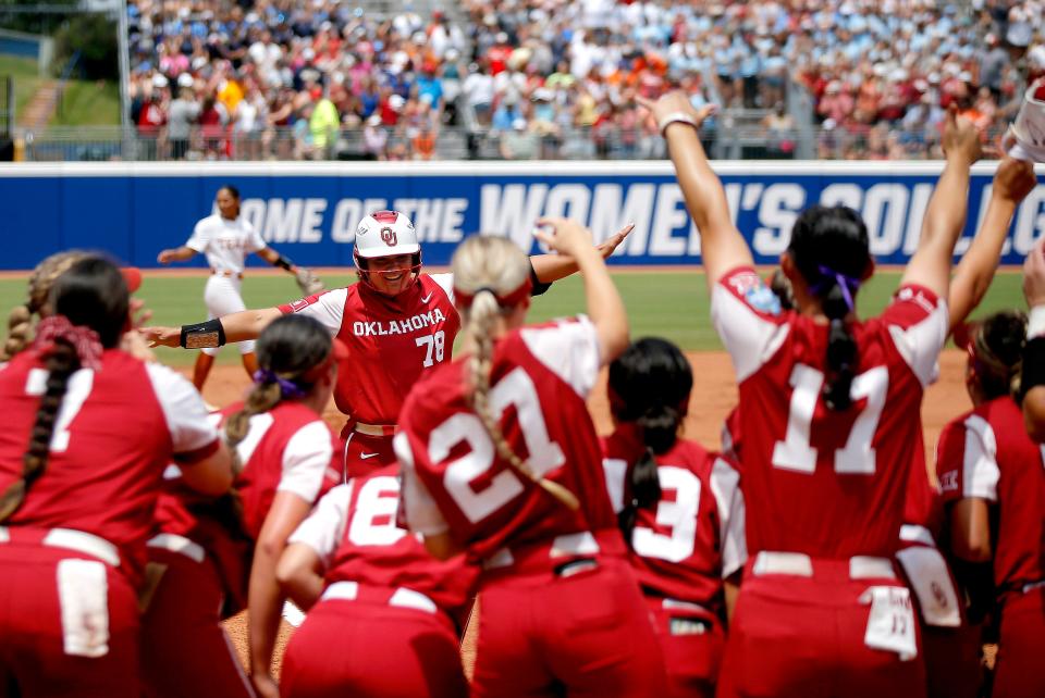 Oklahoma's Jocelyn Alo (78) celebrates a home run with teammates in the first inning Women's College World Series softball game between the Oklahoma Sooners and the Texas Longhorns at USA Softball Hall of Fame Stadium in Oklahoma City , Saturday, June, 4, 2022. 