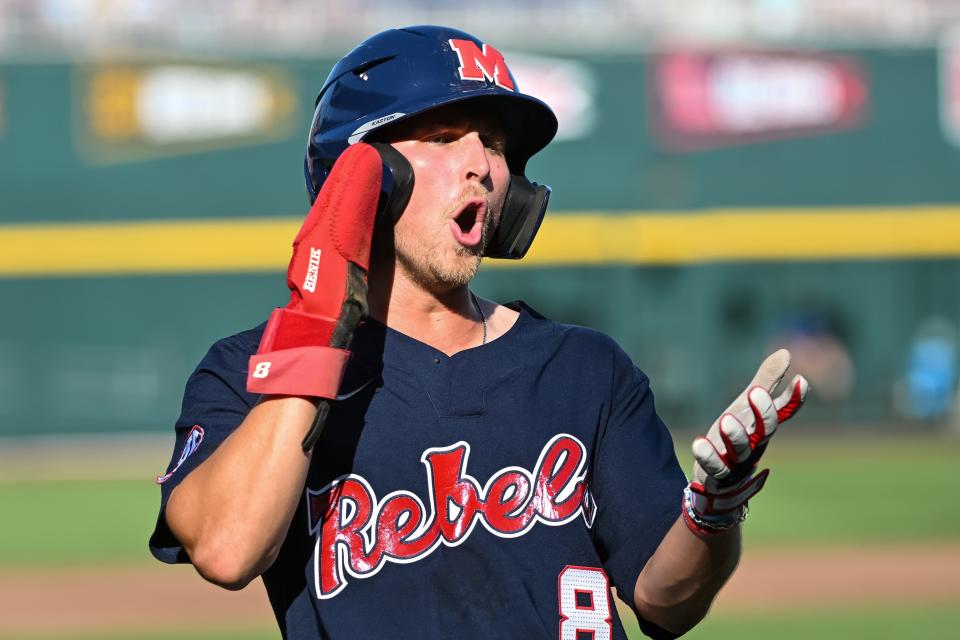 Jun 20, 2022; Omaha, NE, USA; Ole Miss Rebels center fielder Justin Bench (8) celebrates after scoring the first run of the game against the Arkansas Razorbacks in the first inning at Charles Schwab Field. Mandatory Credit: Steven Branscombe-USA TODAY Sports