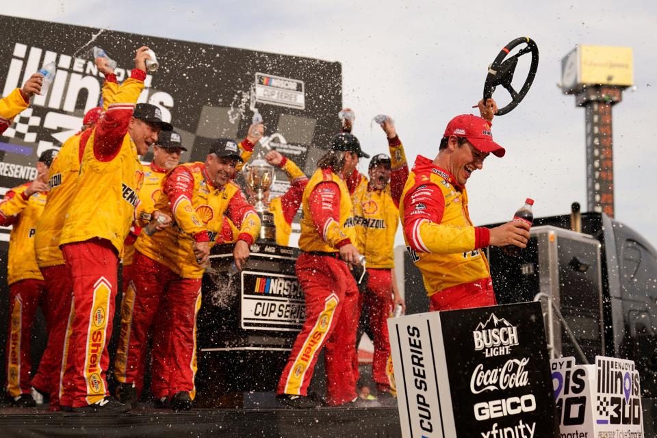 Joey Logano, right, celebrates with members of his crew after winning a NASCAR Cup Series auto race at World Wide Technology Raceway, Sunday, June 5, 2022, in Madison, Ill. (AP Photo/Jeff Roberson)