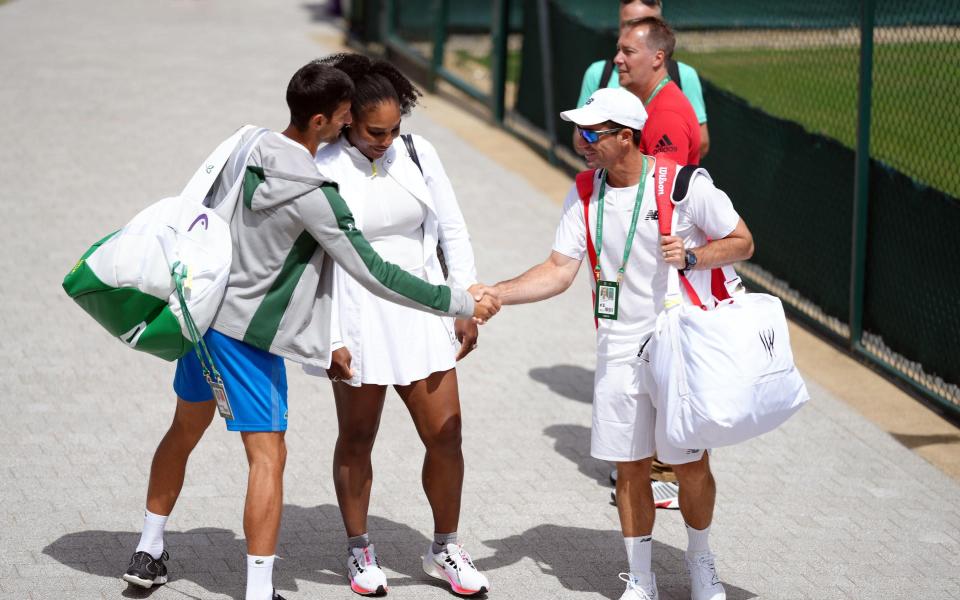 Novak Djokovic shakes the hand of Serena Williams' (centre) coach Eric Hechtman (right) on day two of the 2022 Wimbledon Championships at the All England Lawn Tennis and Croquet Club, Wimbledon.&nbsp; - PA