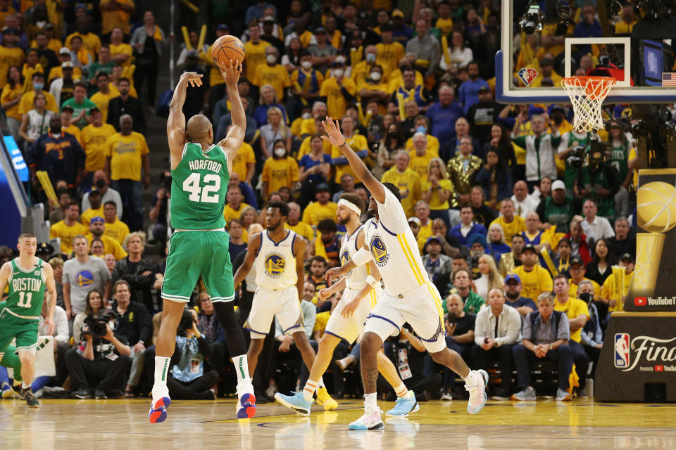 Boston Celtics forward Al Horford attempts a 3-pointer against Golden State's Kevon Looney during the fourth quarter in Game 1 of the 2022 NBA Finals at Chase Center in San Francisco on June 2, 2022. (Ezra Shaw/Getty Images)