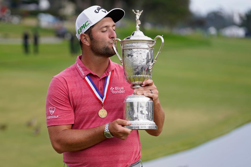 Jon Rahm, of Spain, kisses the champions trophy for photographers after the final round of the U.S. Open Golf Championship, Sunday, June 20, 2021, at Torrey Pines Golf Course in San Diego.