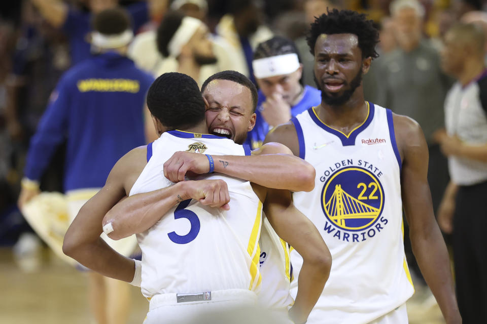 Golden State Warriors guard Jordan Poole, left, celebrates with guard Stephen Curry, middle, and forward Andrew Wiggins after scoring against the Boston Celtics during Game 2 of the 2022 NBA Finals in San Francisco on June 5, 2022. (AP Photo/Jed Jacobsohn)