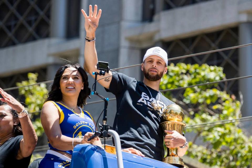 Golden State Warriors’ Stephen Curry accompanied by his wife Ayesha, left, holds the Larry O’Brien trophy during the NBA Championship parade in San Francisco, Monday, June 20, 2022, in San Francisco.