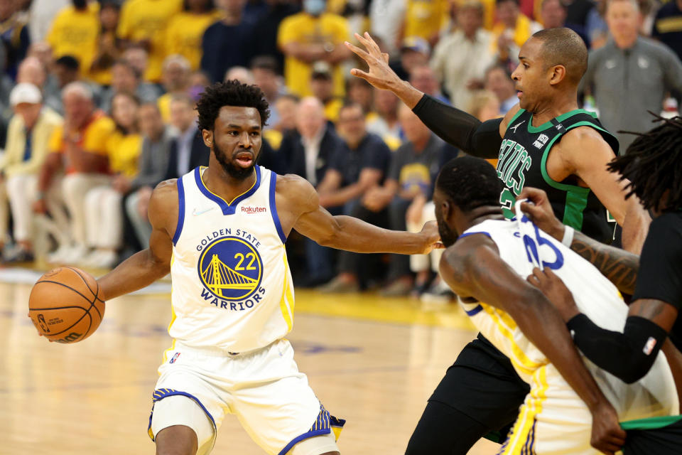 Golden State Warriors forward Andrew Wiggins dribbles against Boston Celtics center Al Horford in Game 5 of the 2022 NBA Finals on June 13, 2022 at Chase Center in San Francisco. (Ezra Shaw/Getty Images)