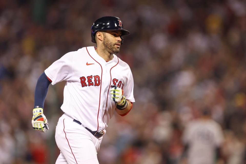 Red Sox designated hitter JD Martinez rounds the bases after hitting a home run.