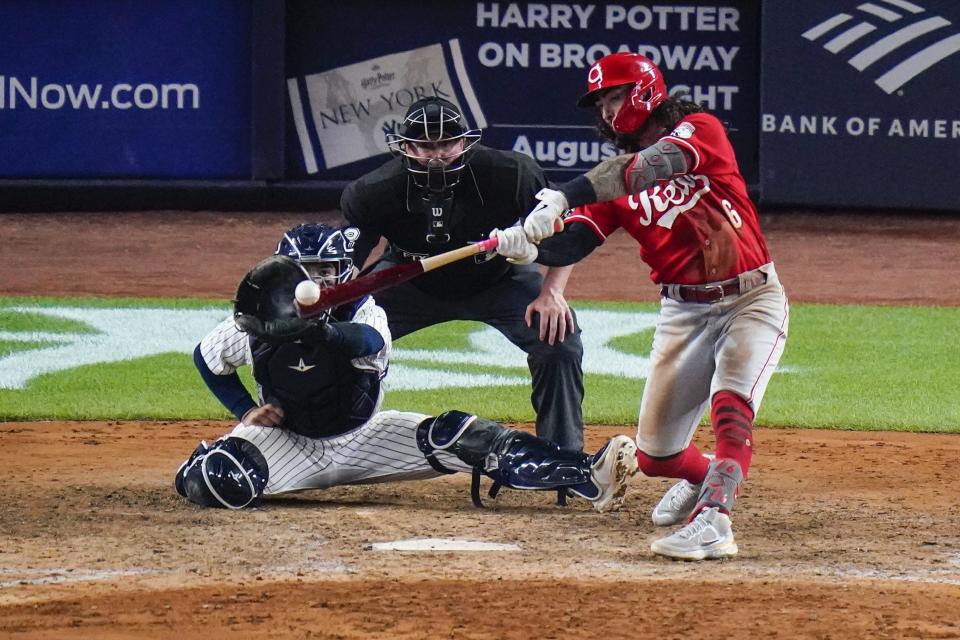 The Cincinnati Reds' Jonathan India hits a two-run single during the ninth inning.