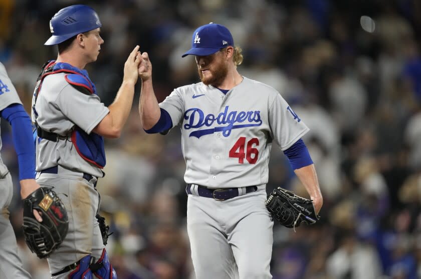 Los Angeles Dodgers catcher Will Smith, left, congratulates relief pitcher Craig Kimbrel.