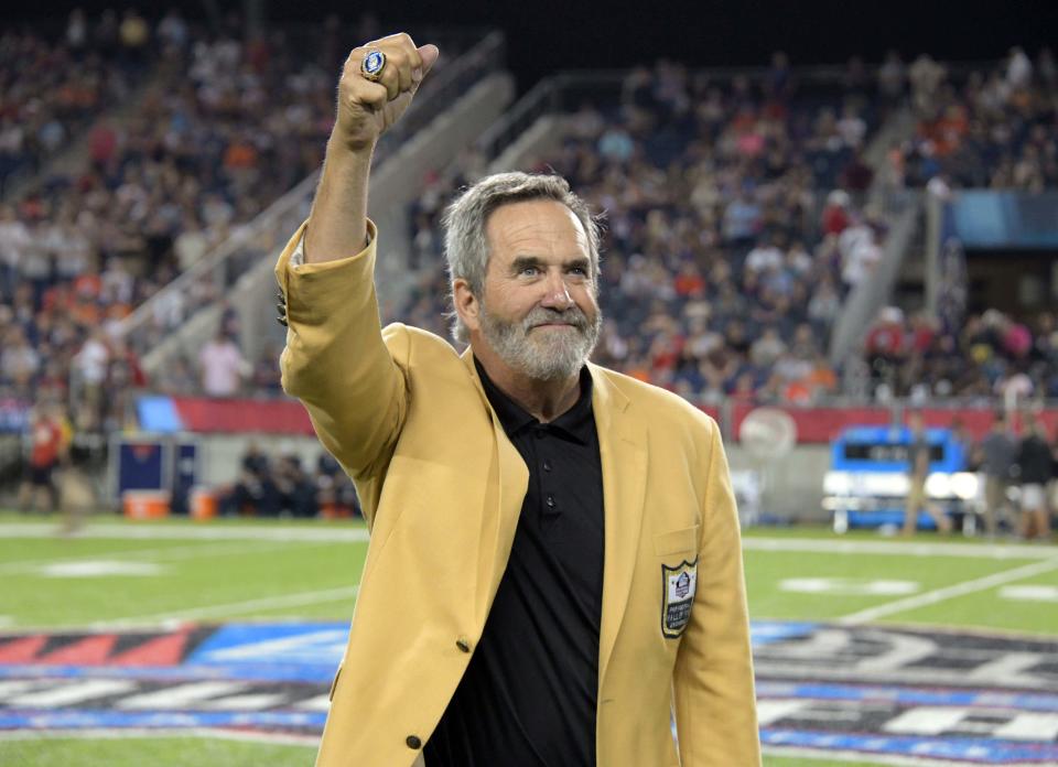 Former San Diego Chargers quarterback Dan Fouts poses with his Hall of Fame ring during the Hall of Fame Game.
