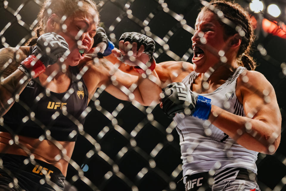 LAS VEGAS, NEVADA - DECEMBER 11: Julianna Pena (R) exchanges punches with Amanda Nunes of Brazil in their women's bantamweight title fight during the UFC 269 event at T-Mobile Arena on December 11, 2021 in Las Vegas, Nevada. (Photo by Carmen Mandato/Getty Images)