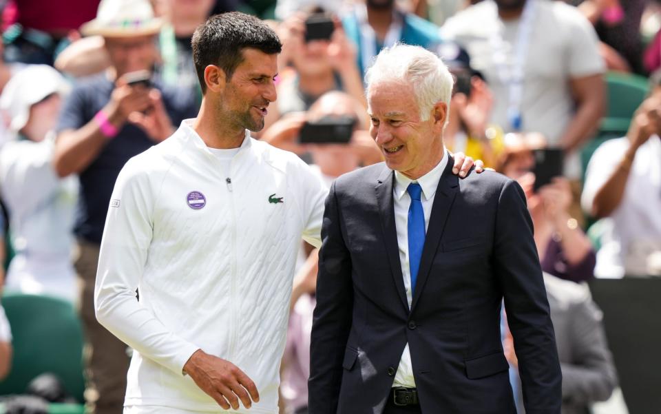 Novak Djokovic (L) of Serbia greet with John McEnroe during the Centre Court Centenary Celebration during day seven of The Championships Wimbledon 2022 at All England Lawn Tennis and Croquet Club on July 03, 2022 in London, England - John McEnroe calls for US vaccine laws to be relaxed for Novak Djokovic - GETTY IMAGES