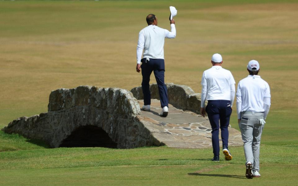 Tiger Woods of the United States acknowledges the crowd as he crosses the Swilcan Bridge&nbsp; - Getty Images