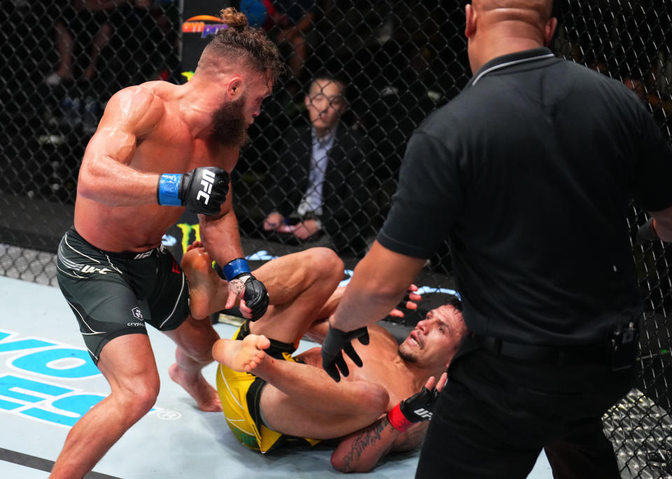 LAS VEGAS, NEVADA - JULY 09: (L-R) Rafael Fiziev of Kazakstan knocks out Rafael Dos Anjos of Brazil in their lightweight fight during the UFC Fight Night event at UFC APEX on July 09, 2022 in Las Vegas, Nevada. (Photo by Chris Unger/Zuffa LLC)