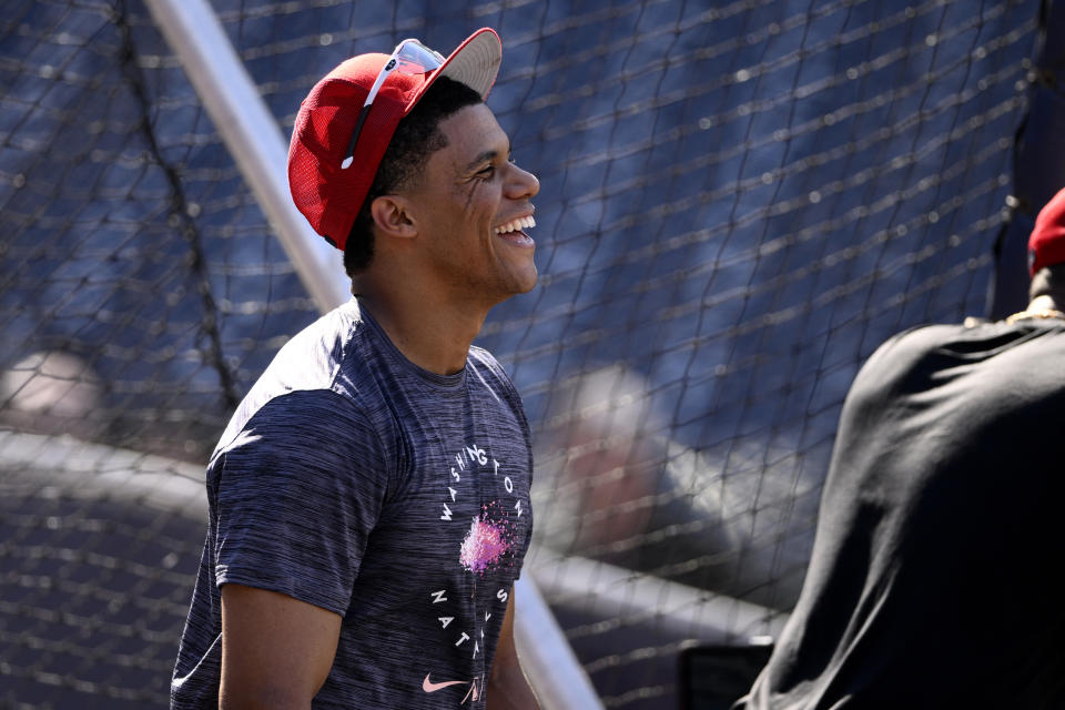 Washington Nationals right fielder Juan Soto (22) reacts during batting practice before a baseball game against the St. Louis Cardinals, Saturday, July 30, 2022, in Washington. (AP Photo/Nick Wass)