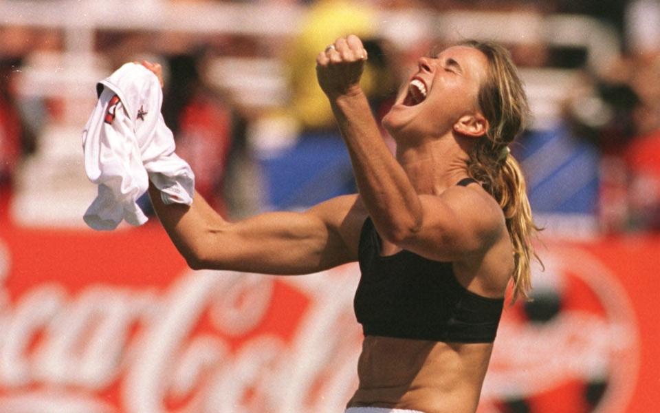 The United States' Brandi Chastain celebrates after kicking the game-winning overtime penalty - AP