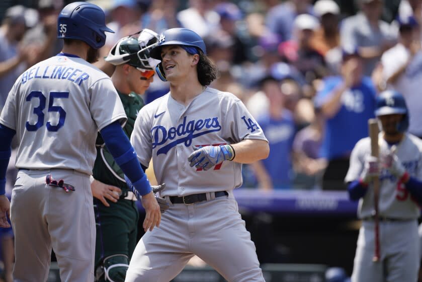 Los Angeles Dodgers' Cody Bellinger, left, congratulates James Outman as he crosses home plate.